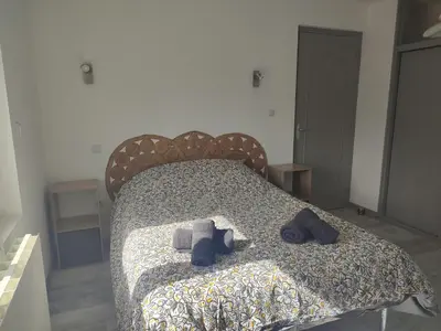 a bedroom with a bed with shoes on it at Au coeur de l'occitanie in Cuq
