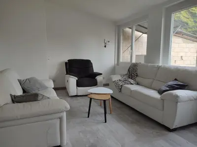 a living room with two white couches and a chair at Au coeur de l'occitanie in Cuq