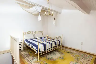 a bedroom with a bed and a rug at Villa en campagne avec cour intérieure in Arques