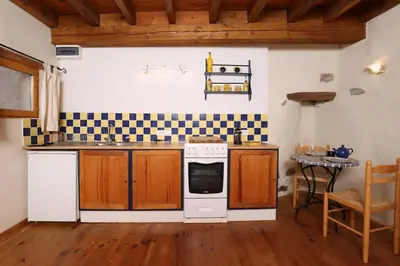 a kitchen with a stove and a sink at Villa en campagne avec cour intérieure in Arques
