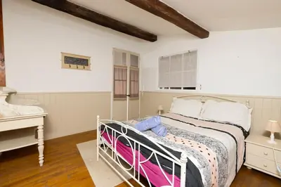 a bedroom with a white bed and a desk at Villa en campagne avec cour intérieure in Arques