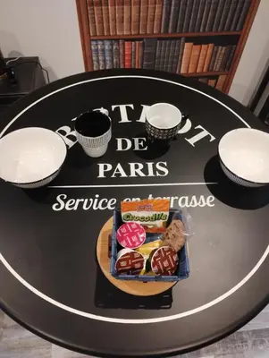 a black table with a tray of pastries on it at Escape Game & Room - Cathédrale - Grands Buffets - Narbonne in Narbonne