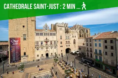 a large building in a city with people walking around at Escape Game & Room - Cathédrale - Grands Buffets - Narbonne in Narbonne