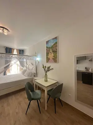 a bedroom with a bed and a table and chairs at Studio à Baldaquin du Cloitre in Narbonne