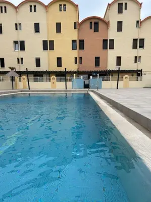 a large swimming pool in front of a building at L'Albatros in Gruissan