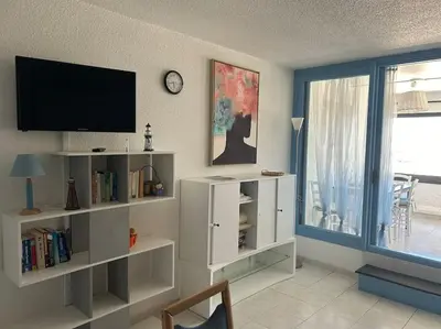 a living room with a flat screen tv on a wall at L'Albatros in Gruissan
