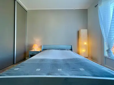 a large bed in a bedroom with a window at Villa des Perdrix - Piscine et Clim - 120m2 in Lavalette