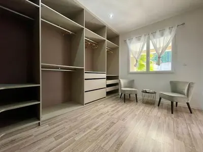 a walk in closet with two chairs and a window at Villa des Perdrix - Piscine et Clim - 120m2 in Lavalette