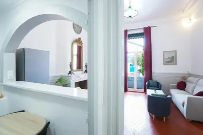 a living room with a couch and a table at Appartement du Forum,La gare, 50 m2 , Climatisation, Garage, Cour in Narbonne