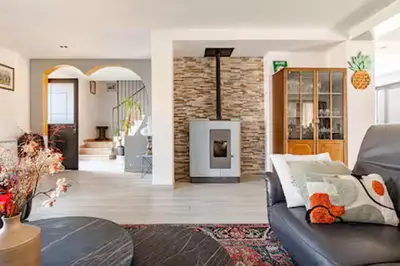 a living room with a couch and a fireplace at Maison Rosy in Carcassonne