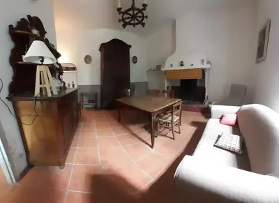 a living room with a table and a couch at Location maison de campagne 5 personnes in Quarante