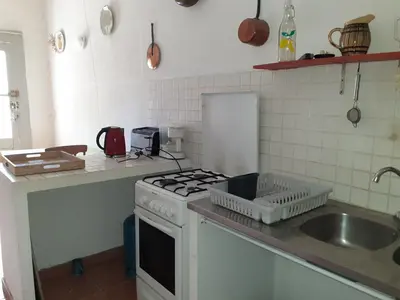 a kitchen with a sink and a stove top oven at Location maison de campagne 5 personnes in Quarante