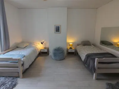 a bedroom with a bed and a ceiling fan at à 5mn de la réserve Africaine, charmante maison de village avec patio in Sigean