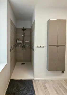a bathroom with two sinks and a fireplace at à 5mn de la réserve Africaine, charmante maison de village avec patio in Sigean