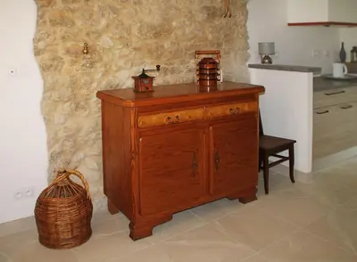 a wooden cabinet in a kitchen with a basket at La Maison de Berthe - Havre de paix dans la campagne - Entièrement rénovée et équipéé in Montmaur