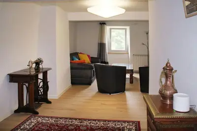 a living room with a couch and a table at La Maison de Berthe - Havre de paix dans la campagne - Entièrement rénovée et équipéé in Montmaur