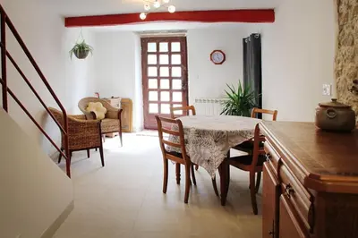 a dining room with a table and chairs at La Maison de Berthe - Havre de paix dans la campagne - Entièrement rénovée et équipéé in Montmaur