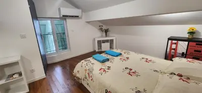 a bedroom with a bed with two pillows on it at Villa Papillons Narbonne Centre in Narbonne