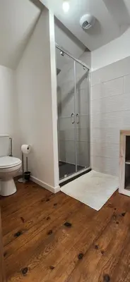 a bathroom with a glass shower and a toilet at Villa Papillons Narbonne Centre in Narbonne