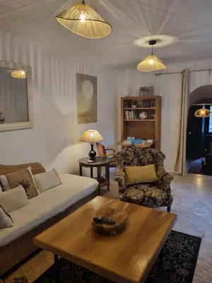 a living room with a couch and a coffee table at Maison de charme in Caunes-Minervois