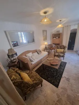a living room with a couch and chairs and a table at Maison de charme in Caunes-Minervois