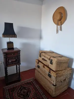 a room with two baskets and a lamp and a table at Maison de charme in Caunes-Minervois