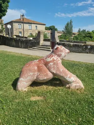 a statue of a bear sitting in the grass at Maison de charme in Caunes-Minervois