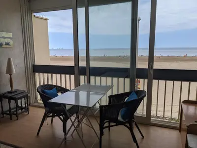 a table and chairs in a room with a view of the beach at T2 Climatisé 4 pers. avec Parking, Front de mer, Port-la-Nouvelle - FR-1-797-10 in Port-la-Nouvelle