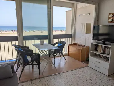 a living room with a table and chairs and a television at T2 Climatisé 4 pers. avec Parking, Front de mer, Port-la-Nouvelle - FR-1-797-10 in Port-la-Nouvelle
