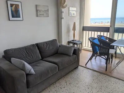 a living room with a couch and a view of the beach at T2 Climatisé 4 pers. avec Parking, Front de mer, Port-la-Nouvelle - FR-1-797-10 in Port-la-Nouvelle