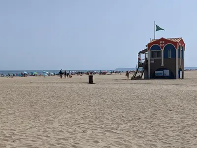 a lifeguard station on a beach with people on it at T2 Climatisé 4 pers. avec Parking, Front de mer, Port-la-Nouvelle - FR-1-797-10 in Port-la-Nouvelle