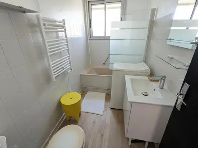 a bathroom with a sink and a toilet and a tub at Bel appartement T2 climatisé avec piscine et parking à 250m de la plage - FR-1-797-9 in Port-la-Nouvelle