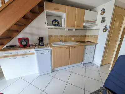 two beds in a small room with a window at Charmante Villa T3 Climatisée Proche Plage - Confort et Calme pour 6 Pers. - FR-1-797-21 in Port-la-Nouvelle