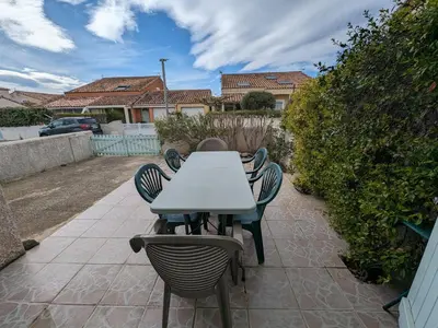 a table and chairs sitting on a patio at Charmante Villa T3 Climatisée Proche Plage - Confort et Calme pour 6 Pers. - FR-1-797-21 in Port-la-Nouvelle