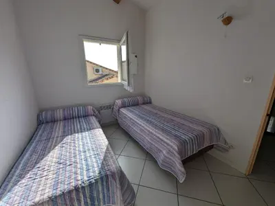 a living room with a bed and a balcony at Charmante Villa T3 Climatisée Proche Plage - Confort et Calme pour 6 Pers. - FR-1-797-21 in Port-la-Nouvelle