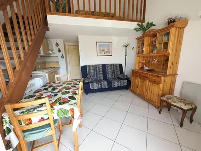 a living room with a staircase and a couch at Charmante Villa T3 Climatisée Proche Plage - Confort et Calme pour 6 Pers. - FR-1-797-21 in Port-la-Nouvelle