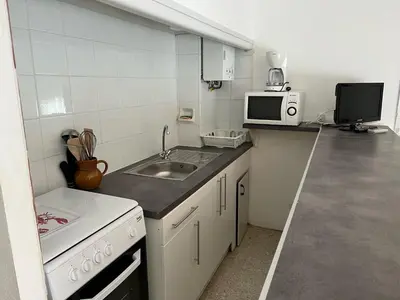 a small kitchen with a sink and a microwave at T2 Climatise en RDC Face Mer 5 Pers PKG - FR-1-797-7 in Port-la-Nouvelle