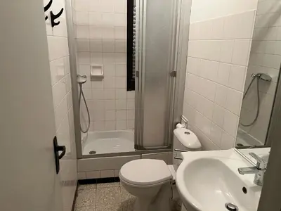 a bathroom with a shower and a toilet and a sink at Appartement T2 climatisé avec parking, près de la plage, 5 couchages - FR-1-797-12 in Port-la-Nouvelle