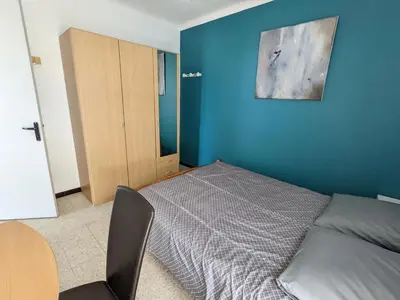 a bedroom with a bed and a blue wall at T2 face mer, climatisé, parking privé, 4 pers - FR-1-797-11 in Port-la-Nouvelle