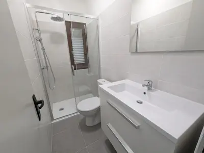 a bathroom with a toilet and a sink and a shower at T2 face mer, climatisé, parking privé, 4 pers - FR-1-797-11 in Port-la-Nouvelle
