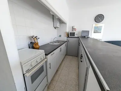 a small kitchen with a sink and a counter at Agréable T2 pour 5 pers, 1er étage, climatisé, parking sécurisé - FR-1-797-6 in Port-la-Nouvelle