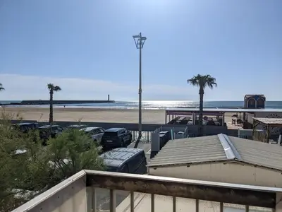 a table and chairs on a balcony with the beach at T3 duplex 50m², 2 chambres, proche plage, 6 pers - FR-1-797-1 in Port-la-Nouvelle