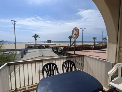 a patio with a table and chairs and the beach at T3 duplex 50m², 2 chambres, proche plage, 6 pers - FR-1-797-1 in Port-la-Nouvelle