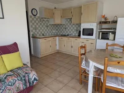 a kitchen with a table and a dining room at Appartement T2 lumineux 40m2, 4 personnes, 150m de la plage, bien équipé et proche loisirs - FR-1-797-18 in Port-la-Nouvelle