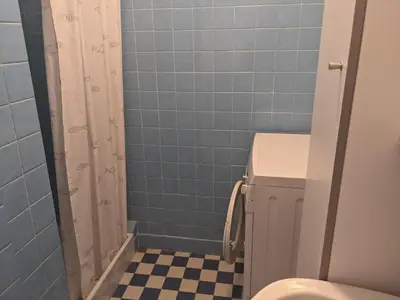 a blue tiled bathroom with a toilet and a shower at Charmant T3 rénové à 60m de la plage avec terrasse, jardin et parking clos - FR-1-797-28 in Port-la-Nouvelle