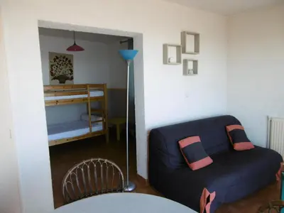 a living room with a couch and a bunk bed at Appartement T4 proche plage et commerces, 80m2, 6 pers, lave-linge, TV - FR-1-797-23 in Port-la-Nouvelle