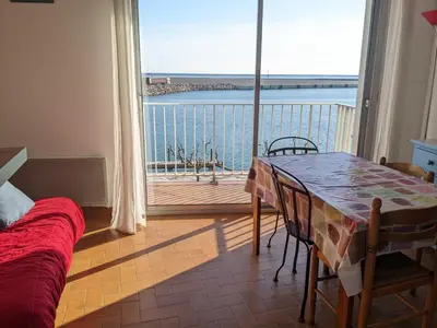 a bedroom with a table and a view of the ocean at Appartement T2 mezzanine 4/5 pers à 250m de la plage, balcon, vue panoramique - FR-1-797-26 in Port-la-Nouvelle