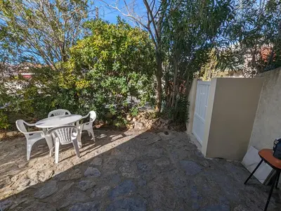 a table and chairs sitting on a patio at Agréable T2, 4 pers, plain-pied ouvert sur terrasse, jardin clos, parking privé, proche plage et commerces - FR-1-797-24 in Port-la-Nouvelle