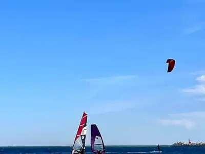 a kite flying in the sky over the ocean at Grand T2 Climatisé 36m² avec Parking à 450m de la Plage - 4 Pers - FR-1-797-34 in Port-la-Nouvelle