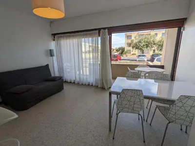 a living room with a couch and a table and chairs at T2 Climatisé, 5 pers, Parking Protégé, Front de mer - FR-1-797-38 in Port-la-Nouvelle
